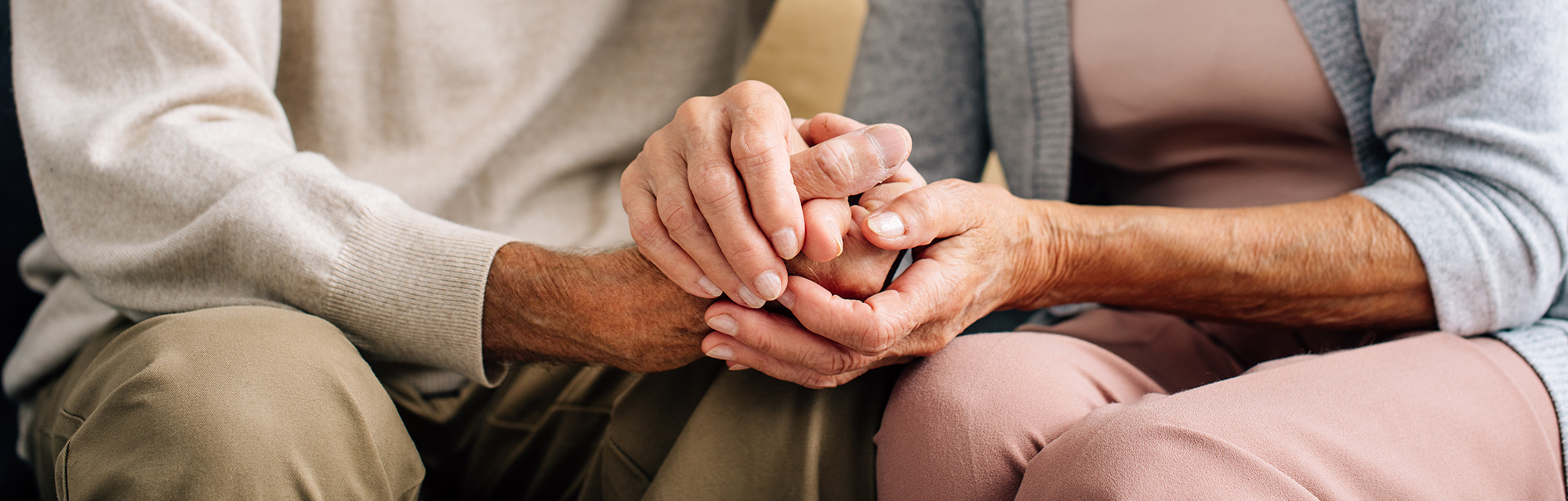 Elderly couple holding hands