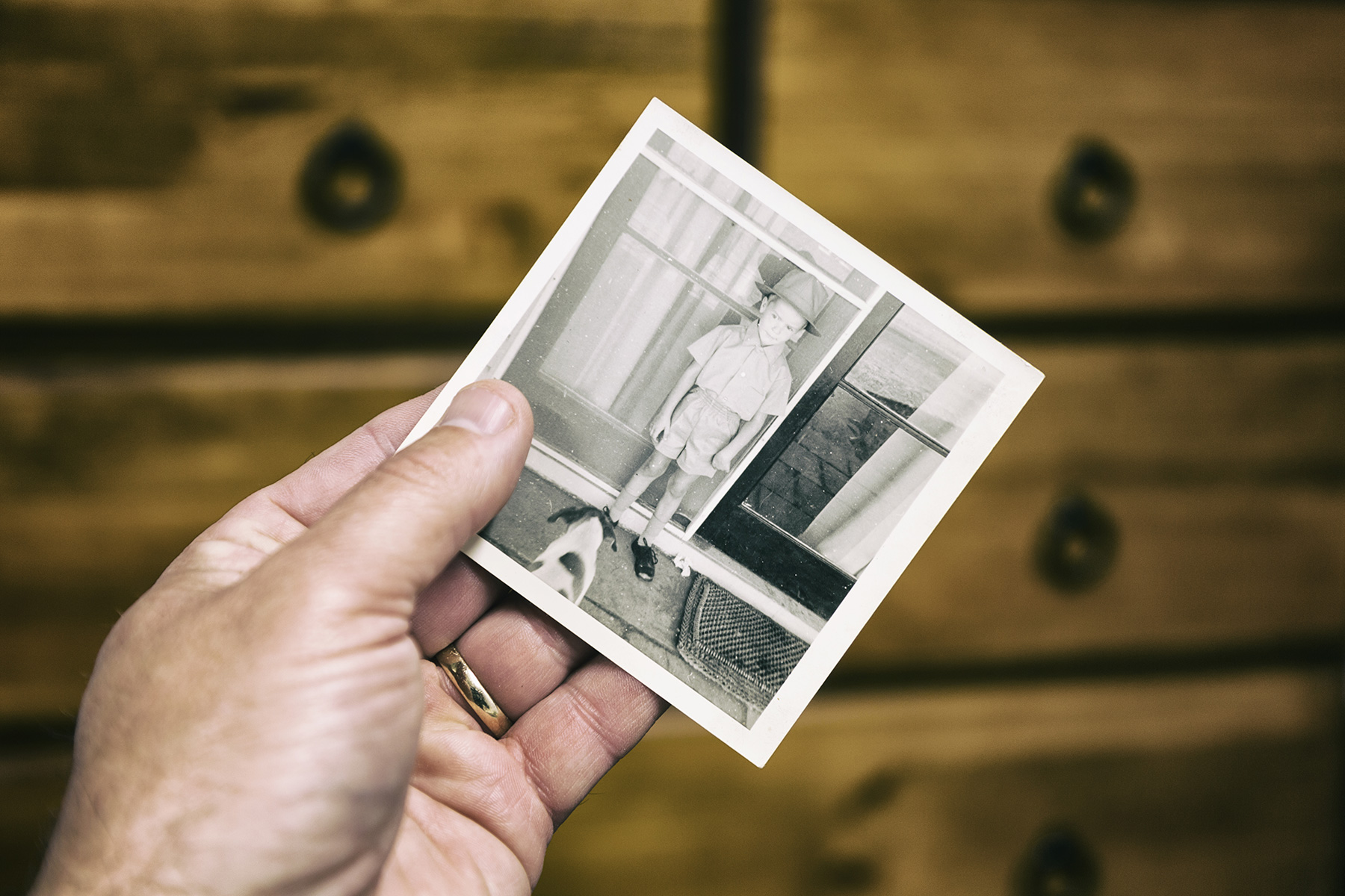 Elderly person looks at old photo