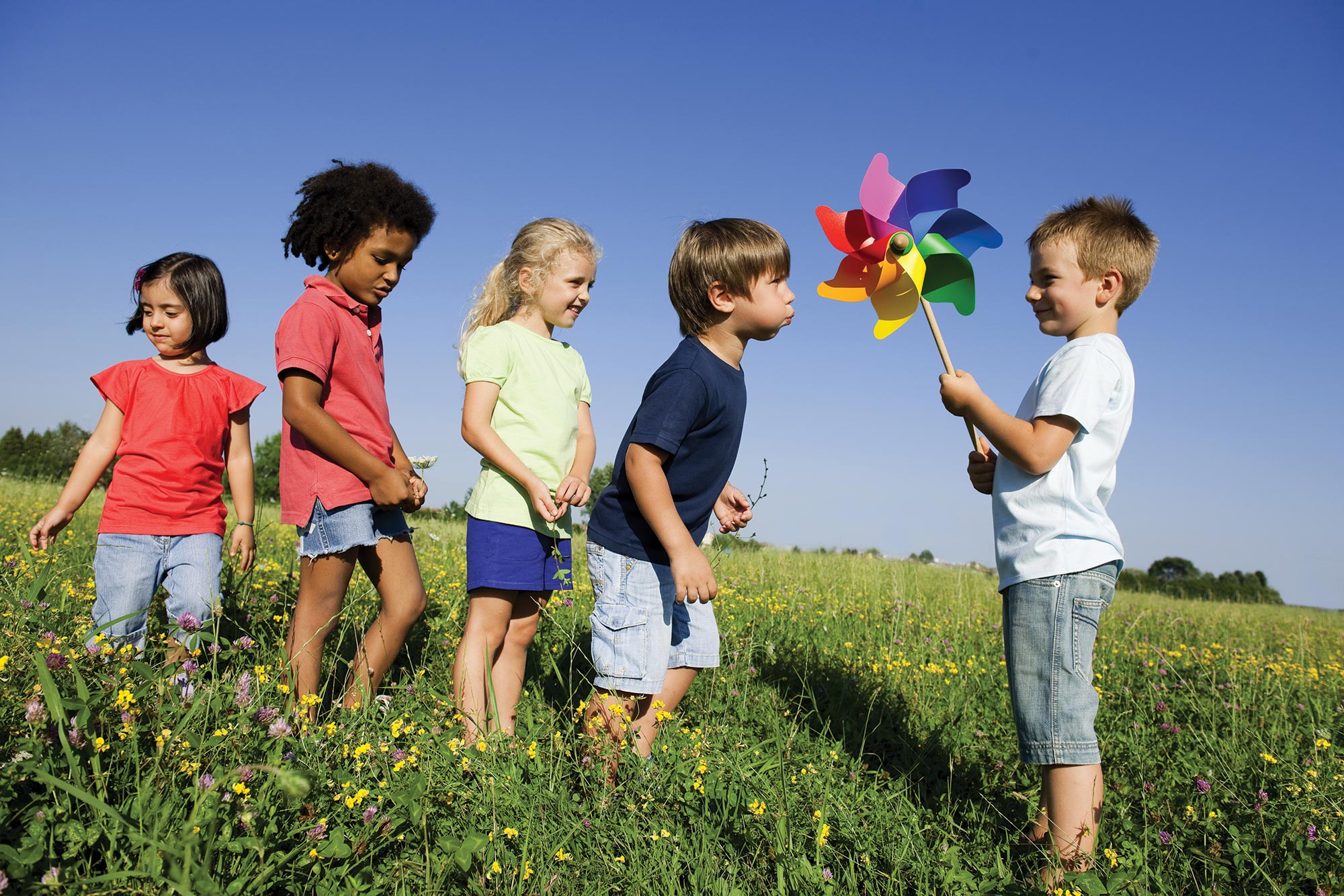 Children play with a pinwheel